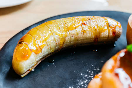 Close up caramel banana for eating with Fluffy pancakes and ice cream.