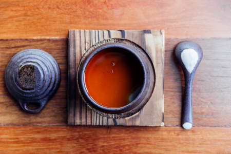 Top view of Japanese Caramel Pudding served in black ceramic cup.の写真素材