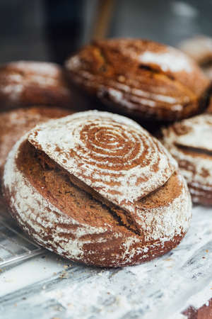 Freshly and warm baked bread rolls place on top marble counter for sell. Homemade by artisan.