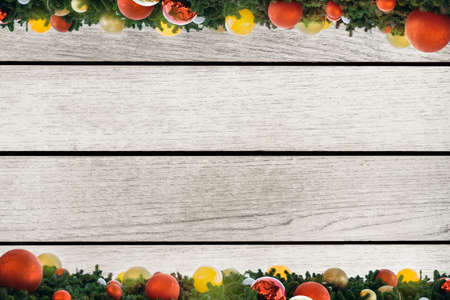 Christmas frame. Christmas color lights balls, pine cones, fir branches on wooden white background. Flat lay, top view, copy space.の写真素材