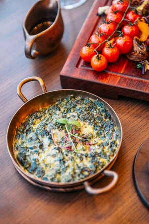 Baked spinach cheese eat with Tomahawk steak with mash potato.の写真素材