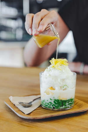 Lod Chong, Thai melon, puffed rice with coconut snow ice topping with sliced jackfruit. Served with caramel.の写真素材