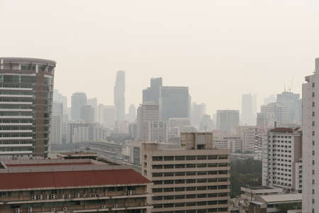 Air pollution effect made low visibility cityscape with haze and fog from dust in the air during sunset in Bangkok, Thailand.のeditorial素材