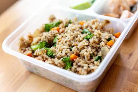 Organic fried salmon diced steak with onion, broccoli and carrot fried rice served with cucumber and...