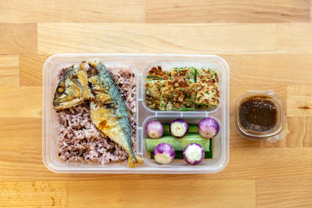 Rice berry and fried mackerel with shrimp-paste sauce served with fried egg climbing wattle, Thai...