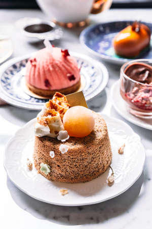 Fluffy sponge cake topping with coffee cream and ice sphere.