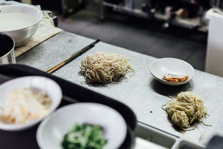 Raw Hakata style ramen noodle with chashu pork on kitchen counter. Prepare for cooking ramen.の写真素材
