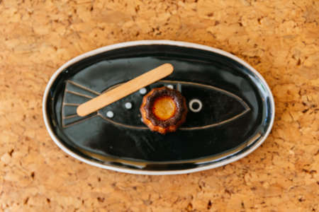Top view of Fresh baked CanelÃ©s, A small French pastry flavored with rum and vanilla with a soft...