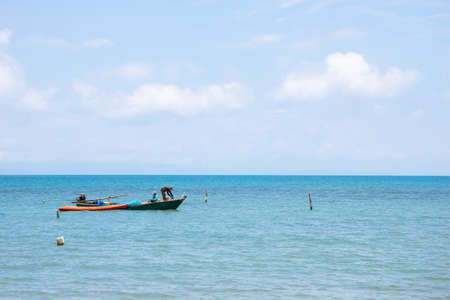 Local Fisherman Boats on the left side floating over the sea with bright sky in background in the afternoon at Koh Mak Island in Trat, Thailand.の写真素材