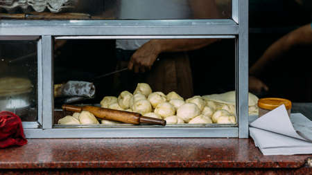 Preparing dough on kitchen counter for making Chicken Kati. Street food in Kolkata, India.の写真素材
