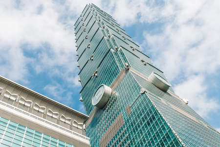 Taipei 101 building from below with bright blue sky and cloud in Taipei, Taiwan. Destination Scenic. Modern Building.のeditorial素材