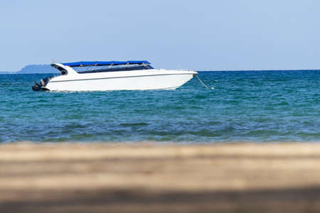 Speedboat is floating over the sea with blur sand beach in foreground in summer in Koh Mak Island at...