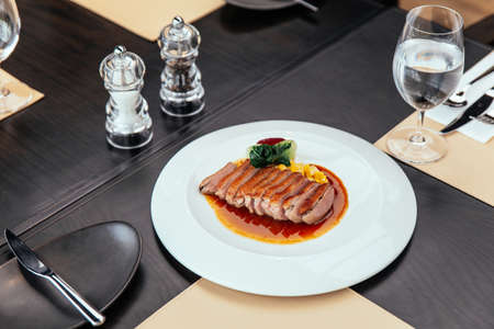 Roasted Duck Breast with cream of corn and tamarind poultry jus, Served with bread and butter.の写真素材