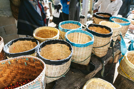 Hand picked ripe red and yellow Arabica Coffee Berries in the baskets at the Akha village of Maejantai on the hill in Chiang Mai, Thailand.の写真素材