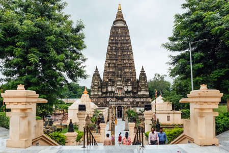 Indian people walking on bare foot to Mahabodhi Temple for praying and pilgrim while raining at Bodh Gaya, Bihar, Indiaのeditorial素材