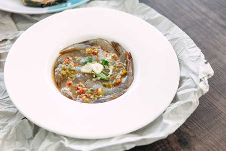 Fish Sauce-Fermented raw shrimps with fresh garlic and chili served in white plate.の写真素材