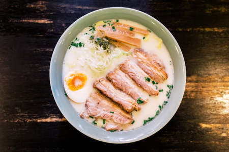 Top view of Ramen Cream Pork Bone Soup (Tonkotsu Ramen) with Chashu Pork, Scallion, Sprout, Onion,...
