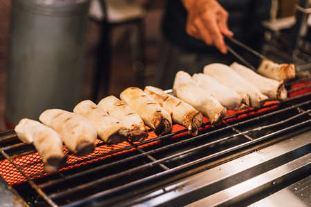Hot Grilled Eryngii Mushroom on electric stove. Street food at Jiantan in Taipei, Taiwan.の写真素材