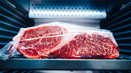 Close-up Premium Rare Sirloin Wagyu A5 beef with high-marbled texture that wrap with plastic inside...