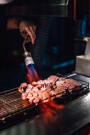 Chef cooking beef cube with blow-torched in medium rare, Juicy and tasty. Street food of Jiantan, Taipei, Taiwan.の写真素材