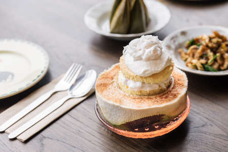 Coconut ice cream cake topping with coconut meat that serve in cut half coconut. Thai fusion...