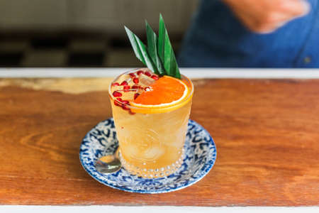 The orange fruity cocktail that mix with sliced orange and pomegranate pulps in a drinking glass....