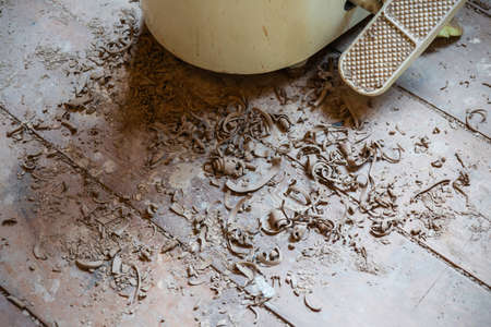 Dry cut pieces of ceramic on the wooden floor. Ceramic handcraft workshop. Hobby and leisure.