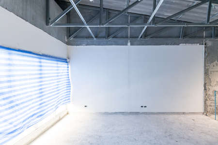 Construction site of empty Interior space, unfinished building after demolition process. Home...