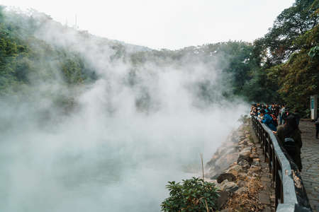 Tourist travel in the famous Beitou Thermal Valley in Beitou Park, boiling steam from hot spring floating through the trees in Taipei City, Taiwan.のeditorial素材