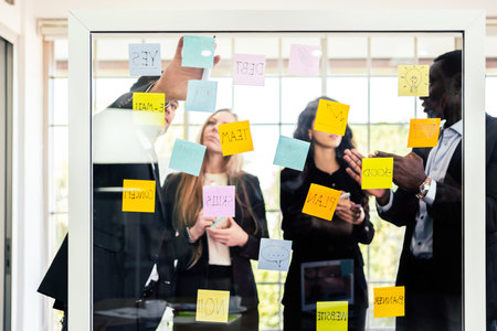 Group of successful business teamwork. Brainstorm meeting with colorful sticky paper note on glass...