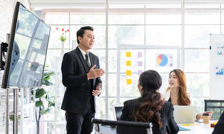 Professional Asian business adviser meeting to analyze and discuss the strategy of financial support of a tech company. Partnership start-up consultant, Indoor business client consultation concept.の写真素材