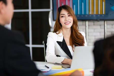 Professional Asian woman business adviser meeting to analyze and discuss the strategy of financial support of a tech company. Partnership start-up consultant, business client consultation concept.の写真素材
