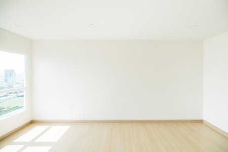 Empty room is decorated with an engineering wooden floor and wallpaper on the wall with sunlight...