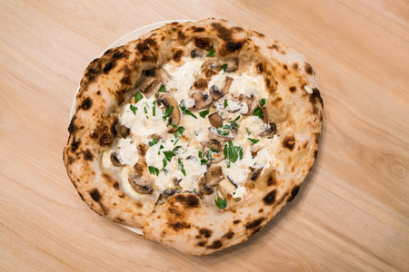 Top view of Neapolitan pizza: Stir-fried Swiss mushrooms topped with special truffle sauce pizza,...
