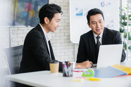 Professional Asian business adviser meeting to analyze and discuss the strategy of financial support of a tech company. Partnership start-up consultant, Indoor business client consultation concept.の写真素材