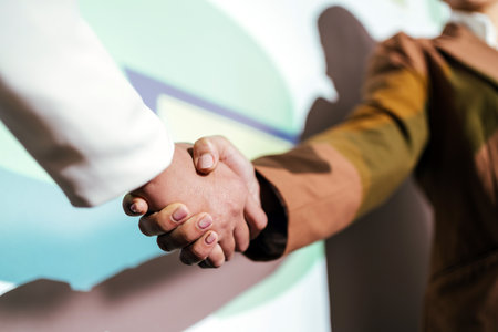 Asian businesswoman handshake with businessman, the teamwork of business mergers and acquisitions for successful negotiation. Two businessmen shake hands with partners to celebrate business deals.の写真素材