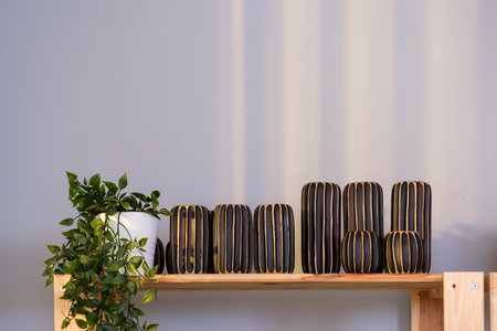 Many groups of handmade wooden vase stock on the shelf at the vase store. Vase stock is ready for delivery for online customers on the shelf for souvenirs or home decoration.の写真素材