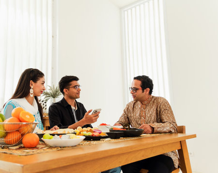 A happy Indian family enjoying a traditional meal together, symbolizing togetherness, culture, and...