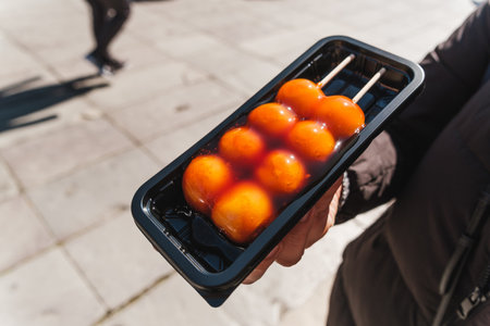 Close-up of freshly prepared mitarashi dango, Traditional Japanese sweet rice dumpling skewered on...