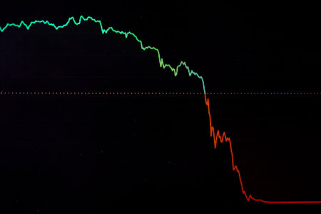 Digital chart showing a sharp downward trend from green to red, symbolizing a stock market crash caused by tariffs or economic tension. Ideal for finance, trade, and economic crisis concepts.の写真素材