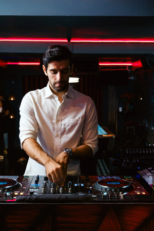DJ performing in a nightclub with neon lights, setting the mood for a vibrant girlsâ night out. Ideal for nightlife, party, and entertainment content emphasizing modern diversity and dance culture.の写真素材