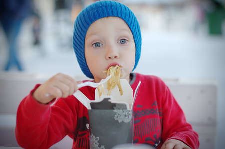 boy eating asian food for lunchの写真素材
