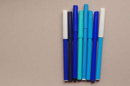 A bunch of blue markers on the gray backgroundの写真素材
