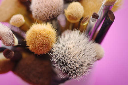 Make up brushes on purple background. Macro view