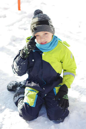 Children play outdoors in snow. Happy boys playing in winter