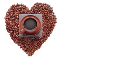 Coffe beans in the shape of a big heart, isolated on white background. Place the text. Top of viewの写真素材