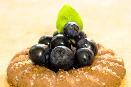 Cookies with blueberries and a leaf on a wooden light backgroundの写真素材