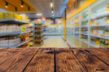 Empty wooden table top on blurred market fruits. can mount or display your products on this countertop in storeの写真素材