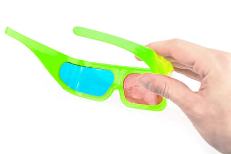 Green 3d glasses in a hand on a white backgroundの写真素材