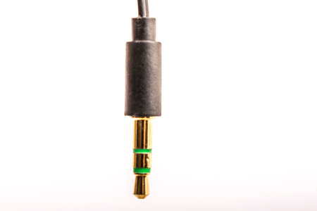 3.5mm headphone jack with wire lies on a white background isolateの写真素材